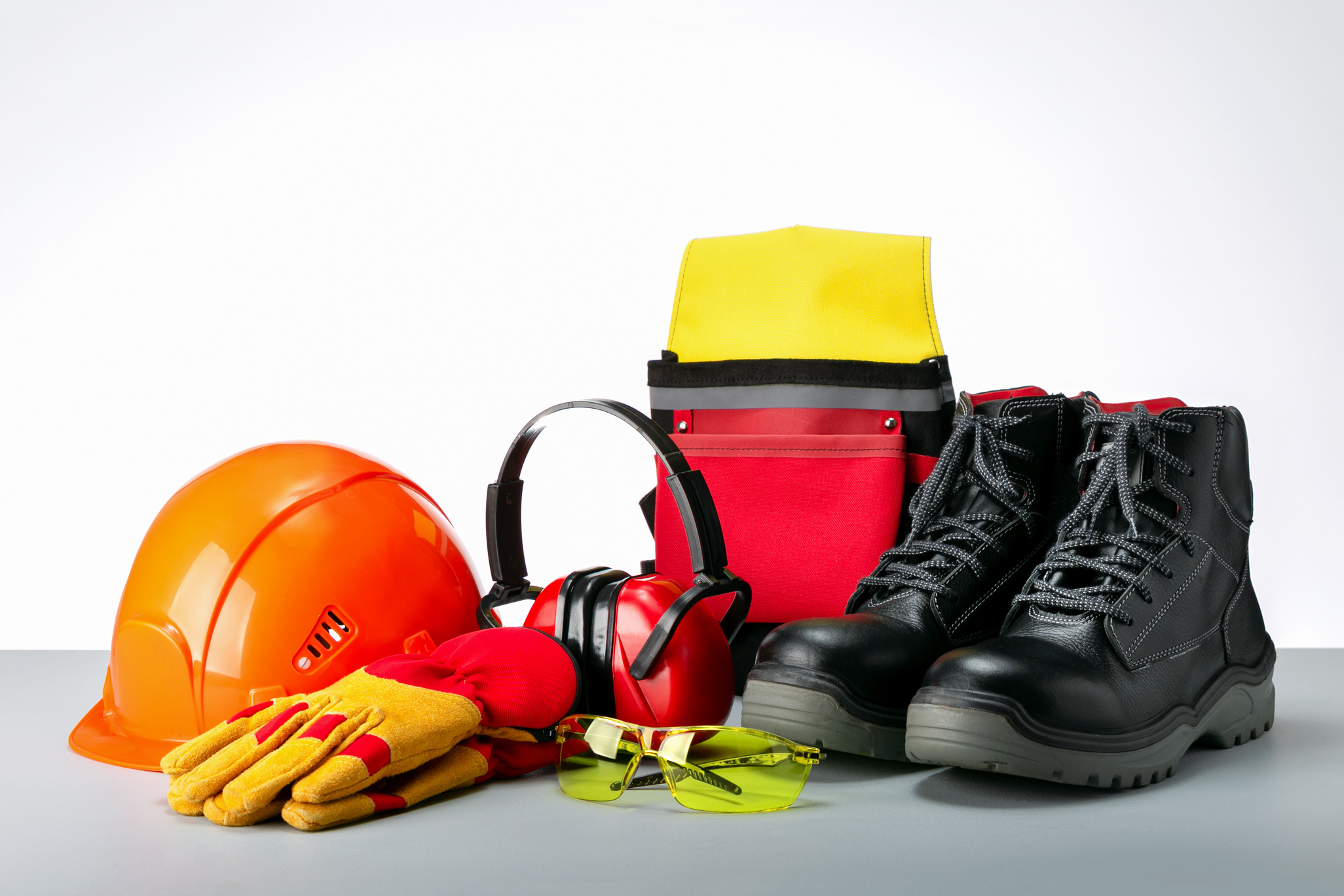 Composition with safety equipment,  protective shoes, safety glasses, gloves and hearing protection.